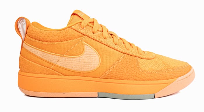 Side view of Devin Booker's orange Nike sneakers.